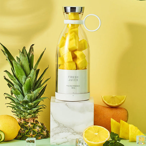 Smoothie Blender with fresh fruits and vegetables on a table.