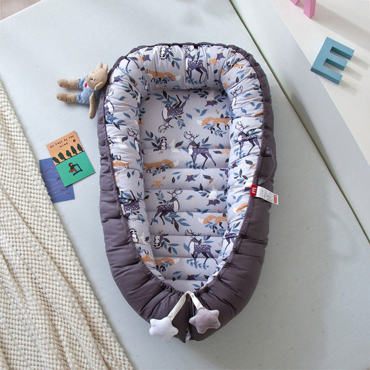 Portable baby crib bed in nursery setting