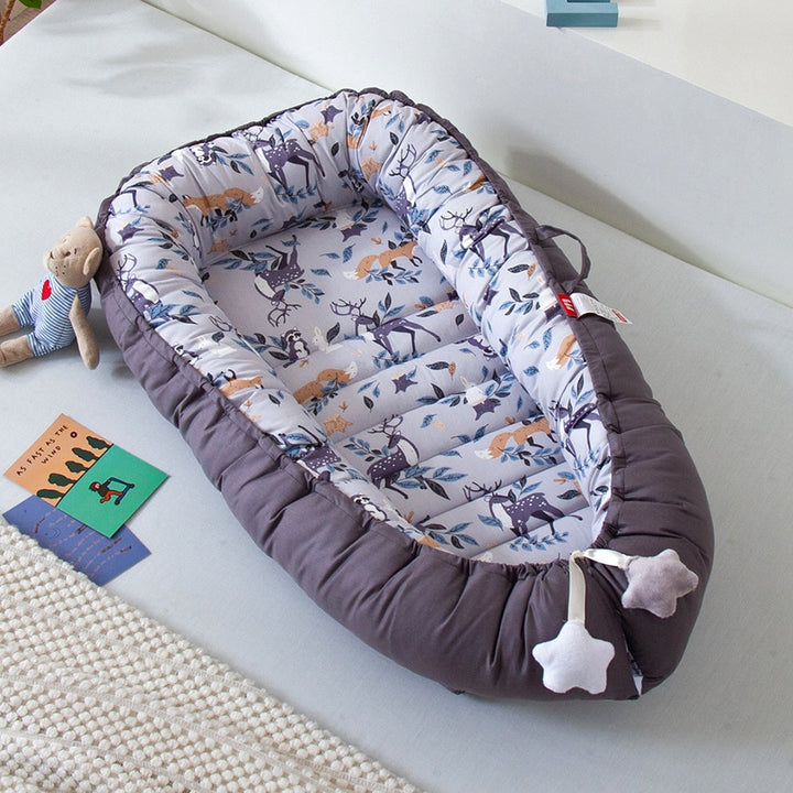 Portable baby crib bed in nursery setting