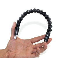 Close-up of the flexible shaft adapter, showcasing its material and flexibility.