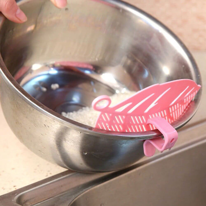 Durable leaf shape rice wash sieve in white color with handle.