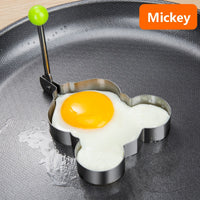Stainless steel egg and pancake shaper with handle.