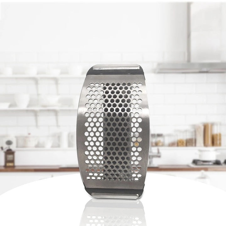 Stainless steel garlic press with rubber handles.