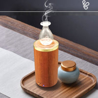 Aromatherapy diffuser with wooden base and glass design