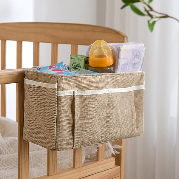 Baby bed organizer with diaper and toy storage capabilities