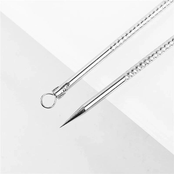 Set of stainless steel blackhead and pimple remover tools in a metal case