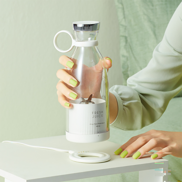 Smoothie Blender with fresh fruits and vegetables on a table.